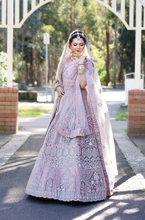 Graceful Pastel Pink Bridal Lehenga with Intricate Embellishments